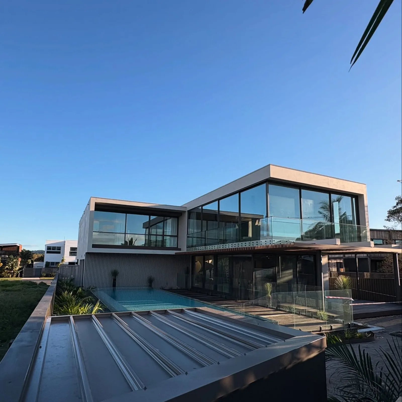 Modern glass and concrete home at dusk